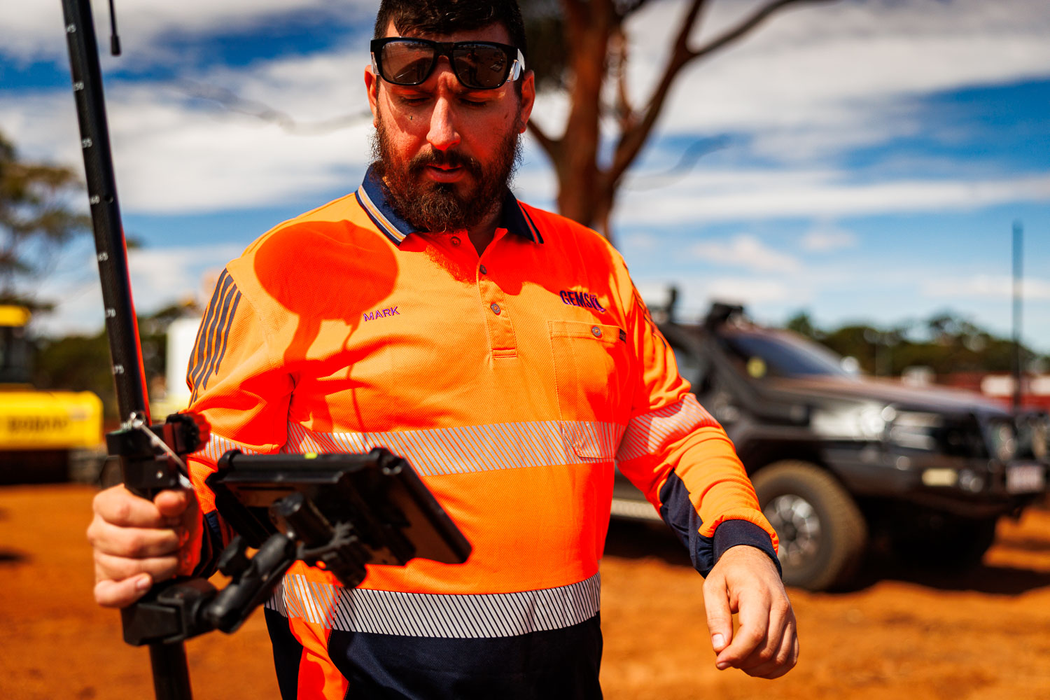 Mark Galus using GPS rover and tablet for precision site survey