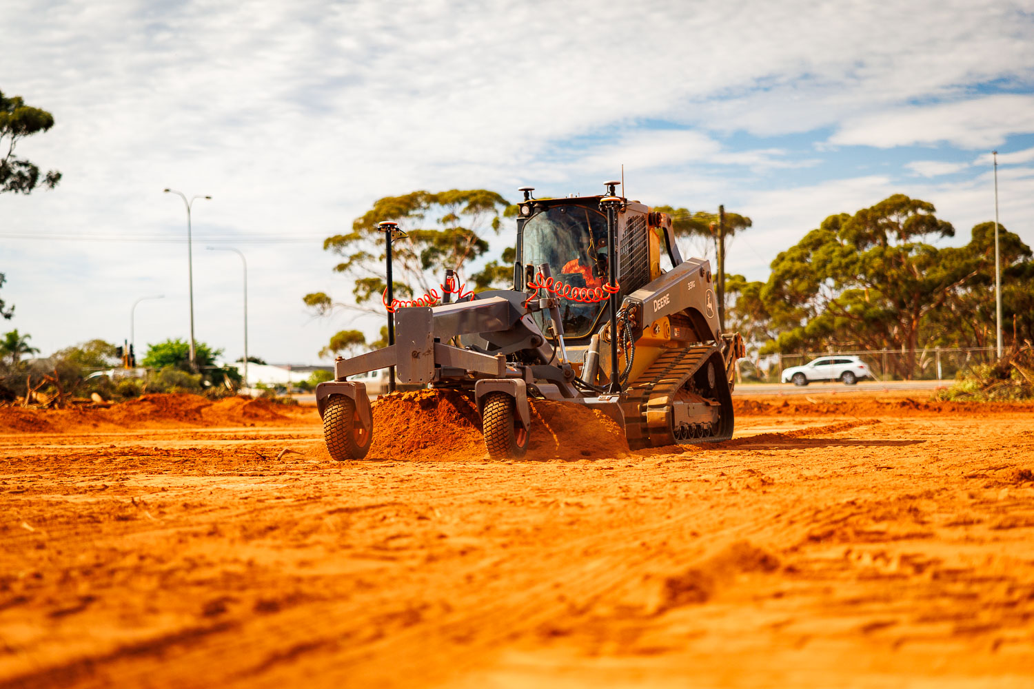 John Deere 331G with laser grade system grading on red earth