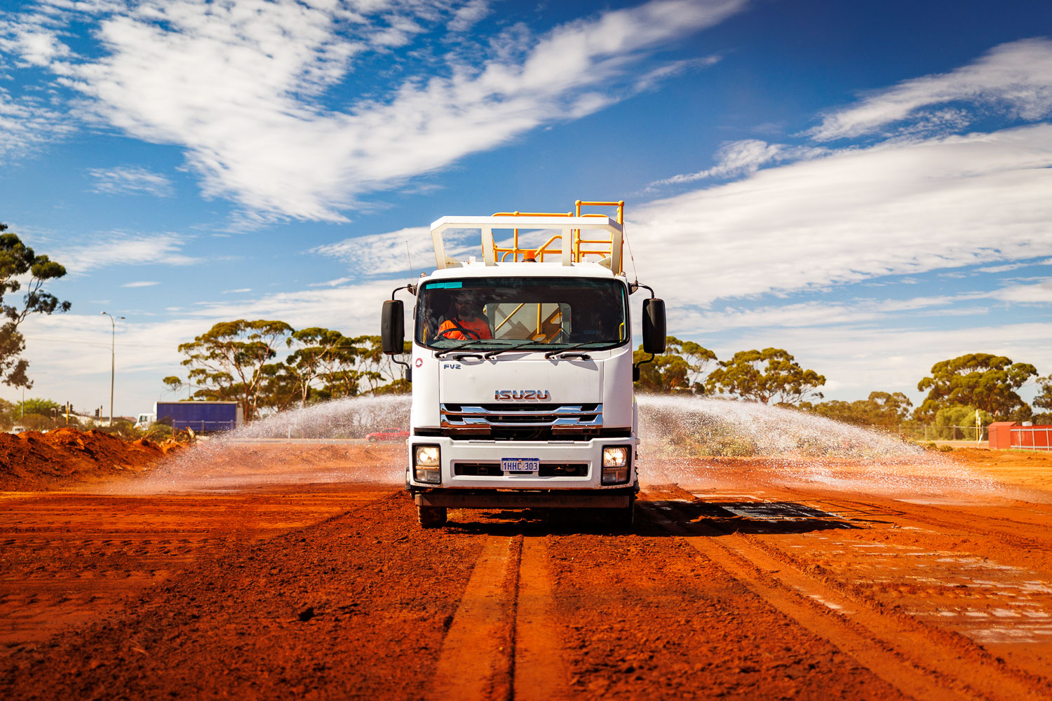 Isuzu water truck dust suppression with full spray arc