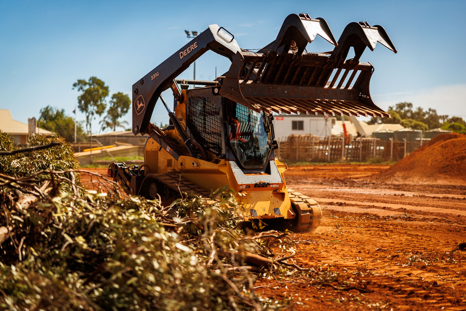 John Deere 331G with skeleton grab clearing vegetation