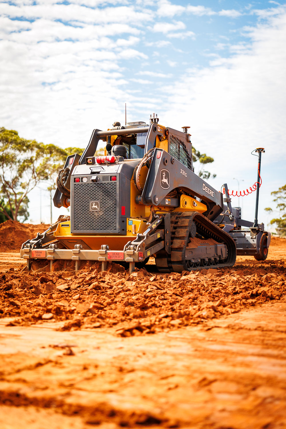 John Deere 331G grading with laser guidance system