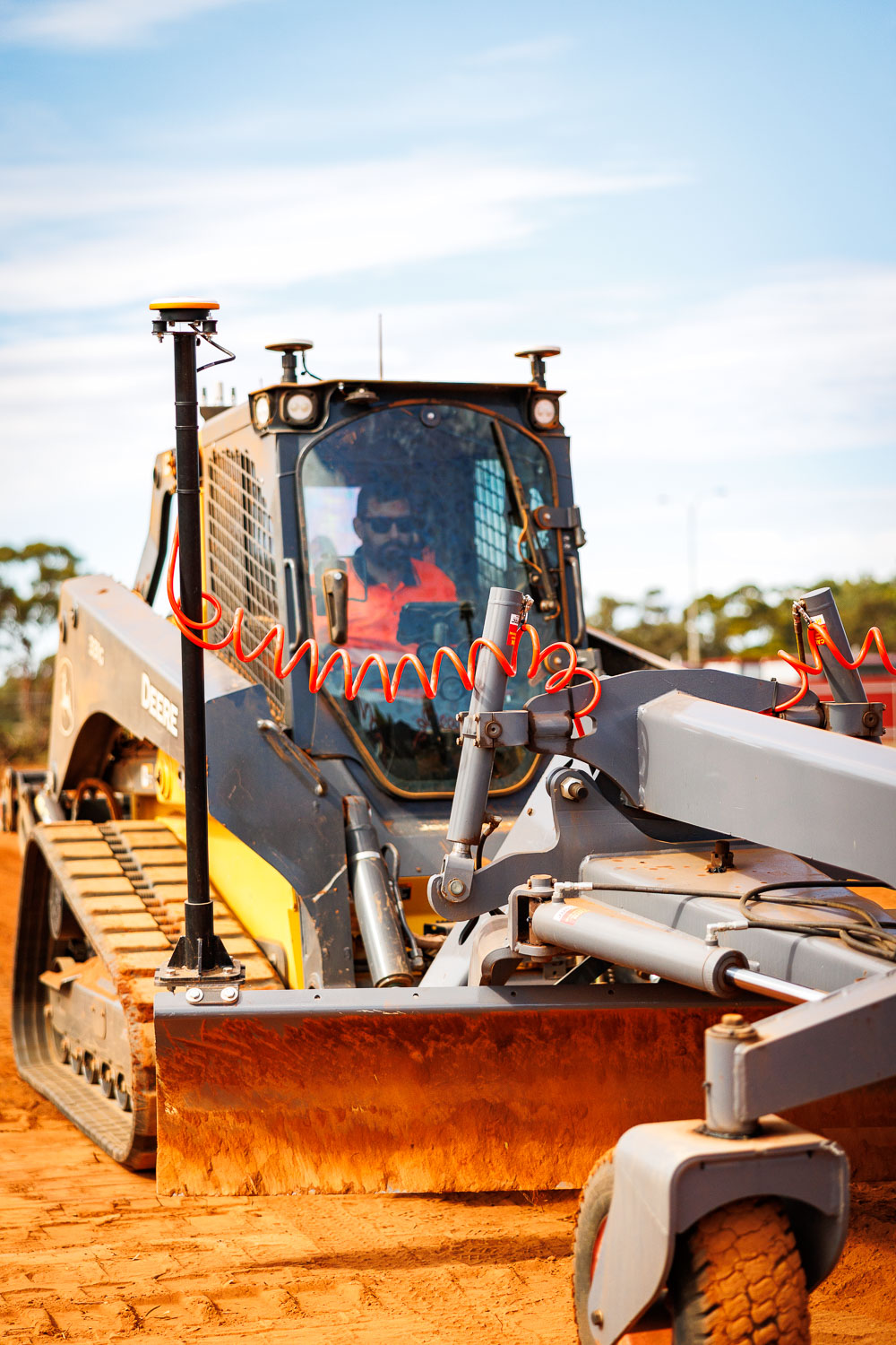 Mark operating John Deere 331G with GPS guidance system